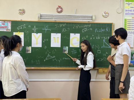 A school ambassador is presenting the Qualification Round of the International Youth Math Challenge to other students