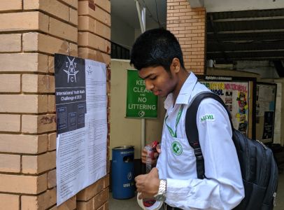 One of the IYMC Ambassadors from India ditributes posters in his school